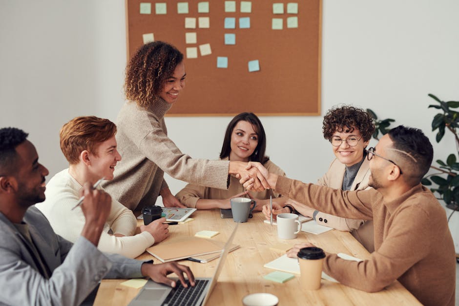 Diverse team collaborating in a meeting, showcasing teamwork and cooperation in a modern workplace. Diverse team collaborating in a meeting, showcasing teamwork and cooperation in a modern workplace.